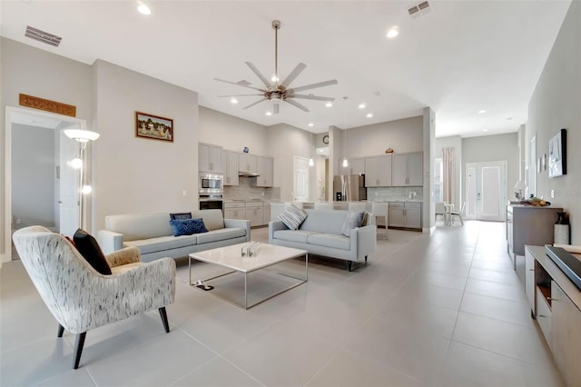 living room featuring a ceiling fan, recessed lighting, light tile patterned floors, and visible vents