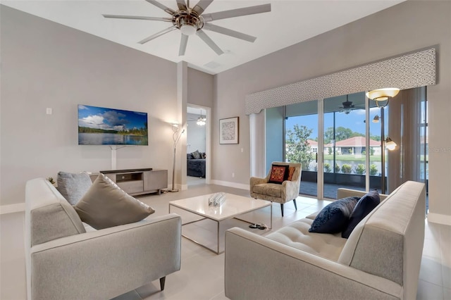 living room with baseboards and ceiling fan