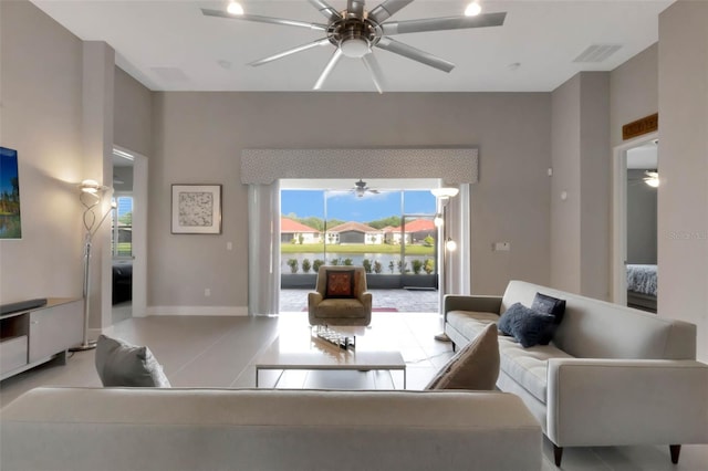 tiled living room featuring baseboards, ceiling fan, and visible vents