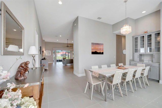 dining space with visible vents, baseboards, recessed lighting, ceiling fan with notable chandelier, and light tile patterned floors