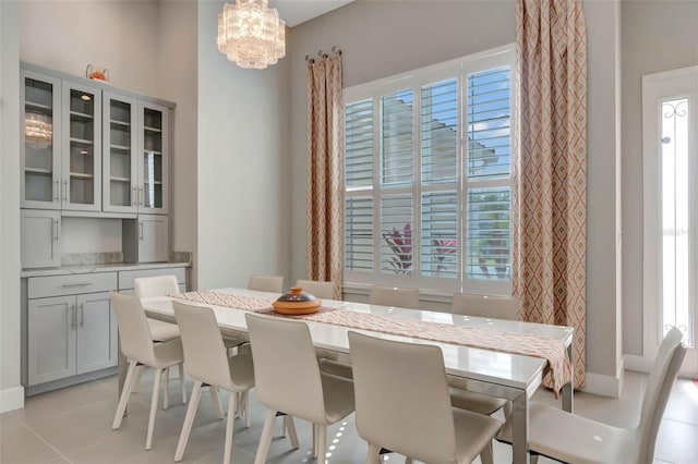 dining room featuring an inviting chandelier and light tile patterned flooring