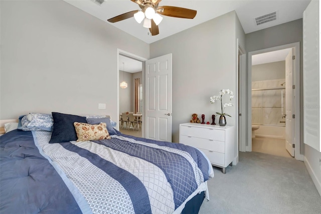 bedroom featuring visible vents, baseboards, ceiling fan, connected bathroom, and light carpet