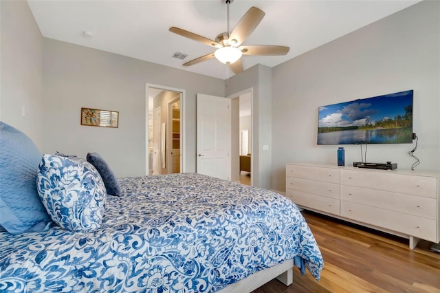 bedroom with visible vents, a ceiling fan, and wood finished floors