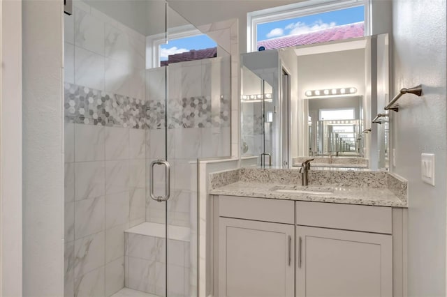 bathroom with vanity and a shower stall