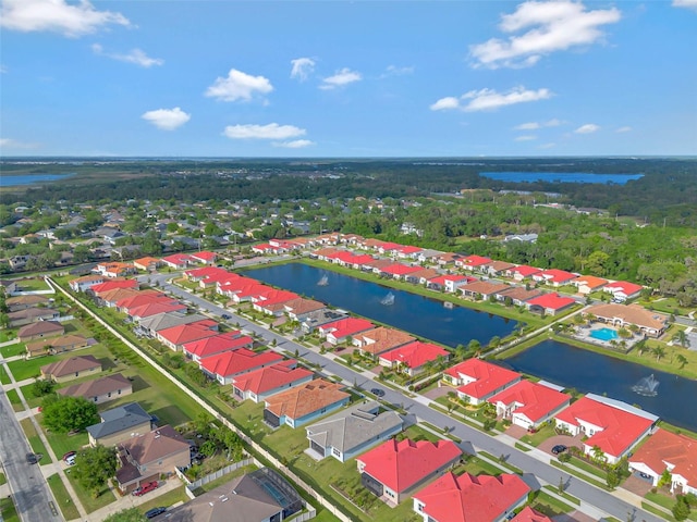 drone / aerial view with a water view and a residential view
