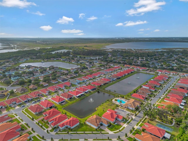 drone / aerial view with a residential view and a water view