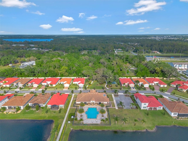 bird's eye view featuring a water view, a wooded view, and a residential view