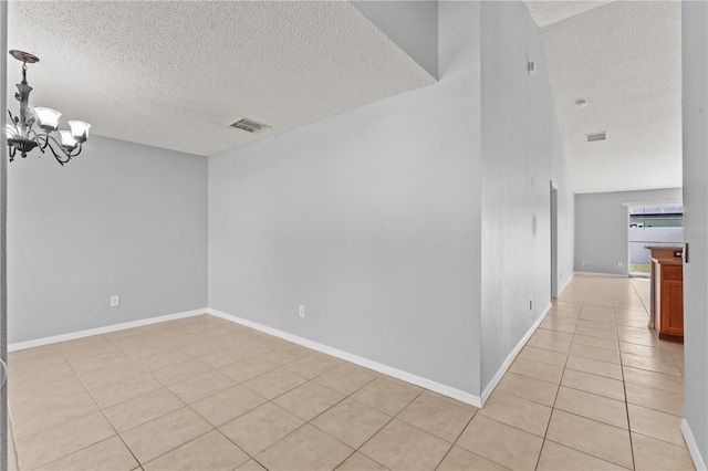 408 Magpie Ct, Kissimmee, FL 34759 - unfurnished room with a textured ceiling, light tile patterned floors, and a chandelier