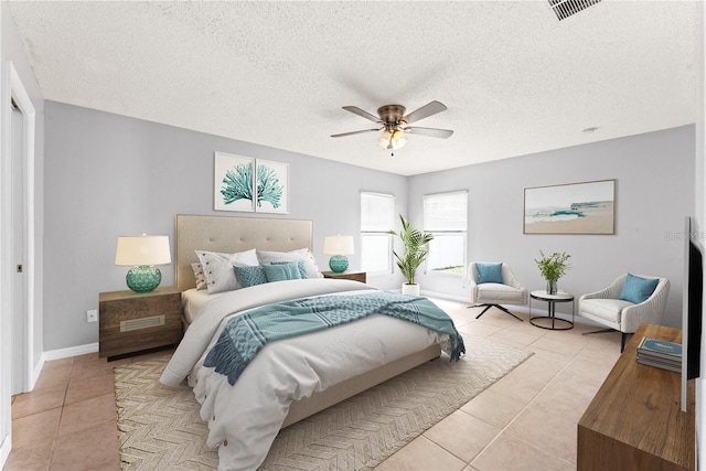 408 Magpie Ct, Kissimmee, FL 34759 - bedroom with light tile patterned flooring, ceiling fan, and a textured ceiling