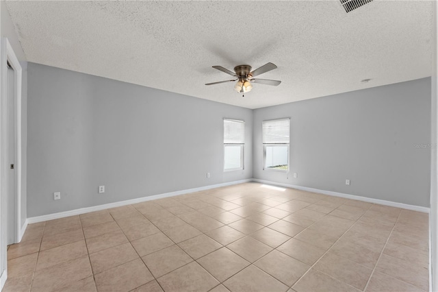 408 Magpie Ct, Kissimmee, FL 34759 - empty room with a ceiling fan, light tile patterned floors, and a textured ceiling