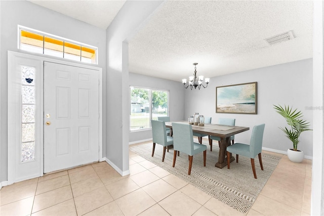 408 Magpie Ct, Kissimmee, FL 34759 - entrance foyer with a chandelier, light tile patterned flooring, and a textured ceiling