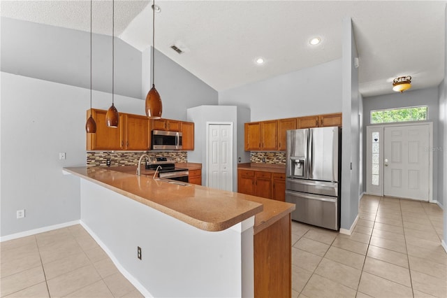 408 Magpie Ct, Kissimmee, FL 34759 - kitchen featuring stainless steel appliances, light tile patterned floors, a peninsula, backsplash, and high vaulted ceiling