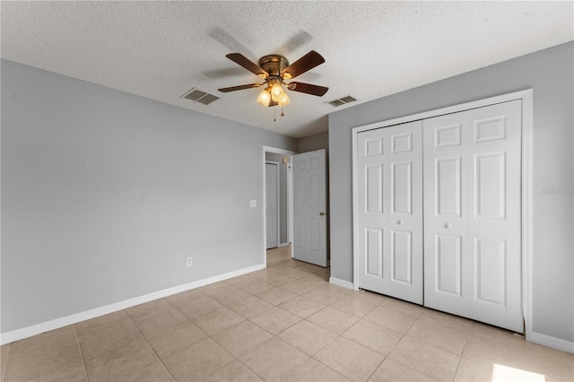 408 Magpie Ct, Kissimmee, FL 34759 - unfurnished bedroom with a textured ceiling, light tile patterned floors, a closet, and ceiling fan