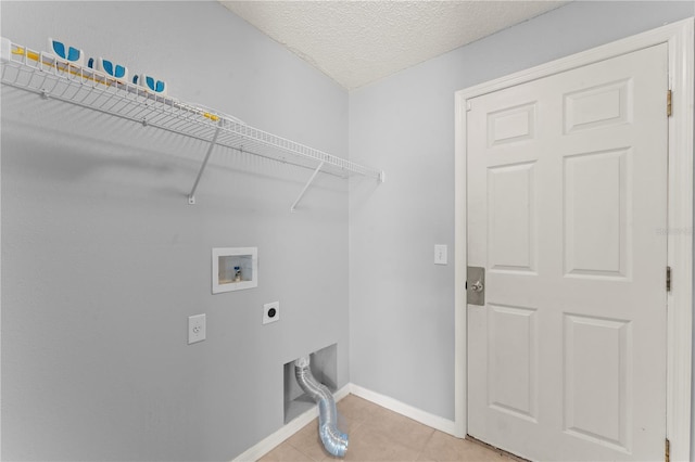 408 Magpie Ct, Kissimmee, FL 34759 - laundry area with hookup for an electric dryer, washer hookup, light tile patterned flooring, and a textured ceiling
