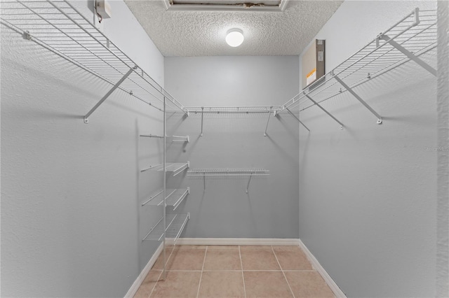 408 Magpie Ct, Kissimmee, FL 34759 - walk in closet featuring tile patterned floors