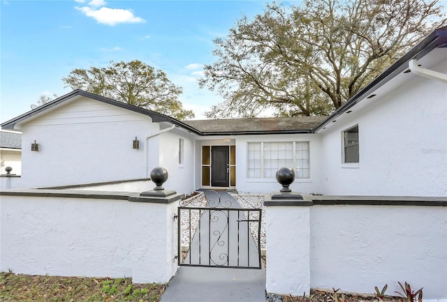 621 Ashberry Ln, Altamonte Springs, FL 32714 - view of exterior entry with a gate, stucco siding, and fence