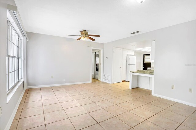 621 Ashberry Ln, Altamonte Springs, FL 32714 - unfurnished living room featuring baseboards, visible vents, and a ceiling fan