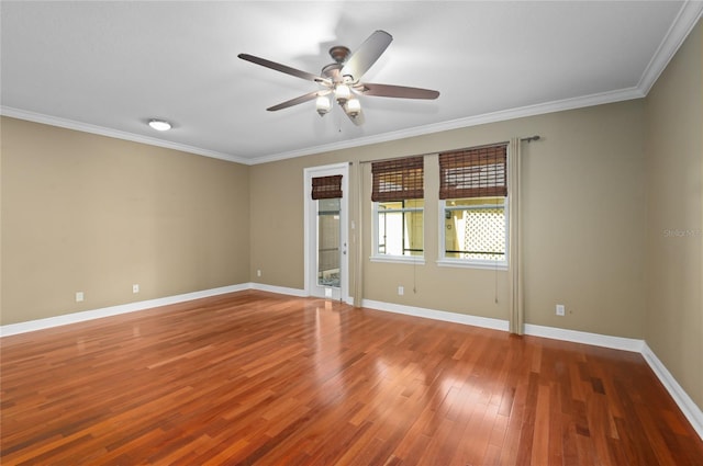 spare room with ornamental molding, baseboards, wood finished floors, and ceiling fan