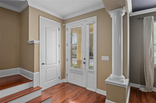 entryway with a wealth of natural light, dark wood-type flooring, and ornate columns
