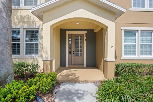 property entrance featuring stucco siding