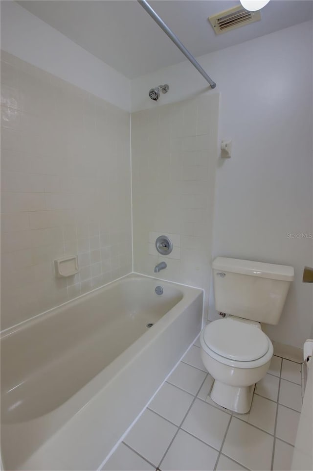 bathroom featuring tile patterned floors, visible vents, toilet, and washtub / shower combination