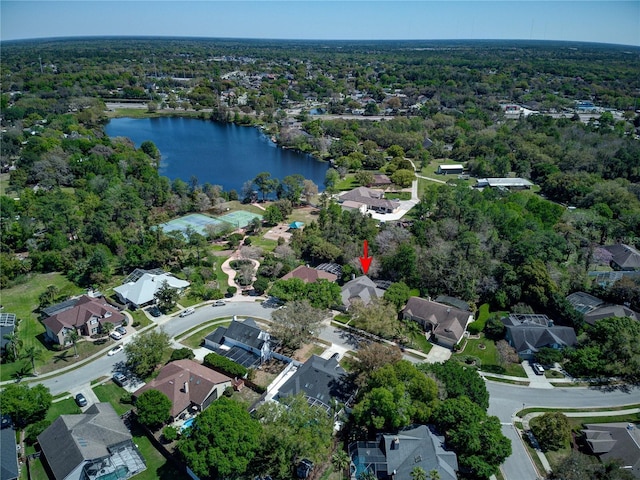 birds eye view of property featuring a water view, a view of trees, and a residential view