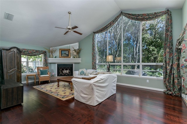 living area featuring a ceiling fan, vaulted ceiling, and hardwood / wood-style flooring