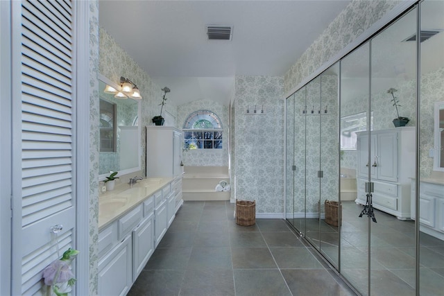 full bath with visible vents, a bath, a sink, wallpapered walls, and tile patterned floors