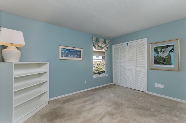 unfurnished bedroom featuring a closet, baseboards, and carpet