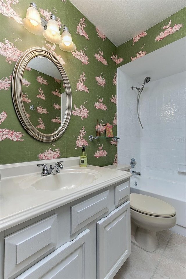 full bathroom featuring tile patterned floors, vanity, toilet, and shower / bath combination