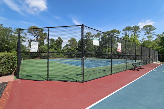 view of sport court featuring fence