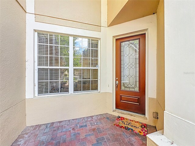entrance to property with stucco siding