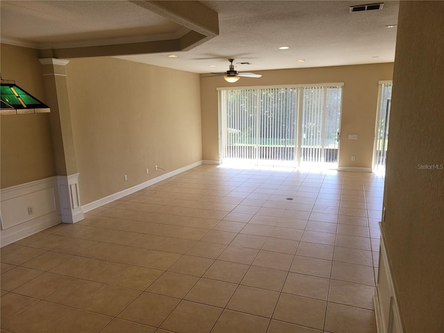 spare room featuring a textured ceiling, a ceiling fan, light tile patterned floors, recessed lighting, and ornamental molding