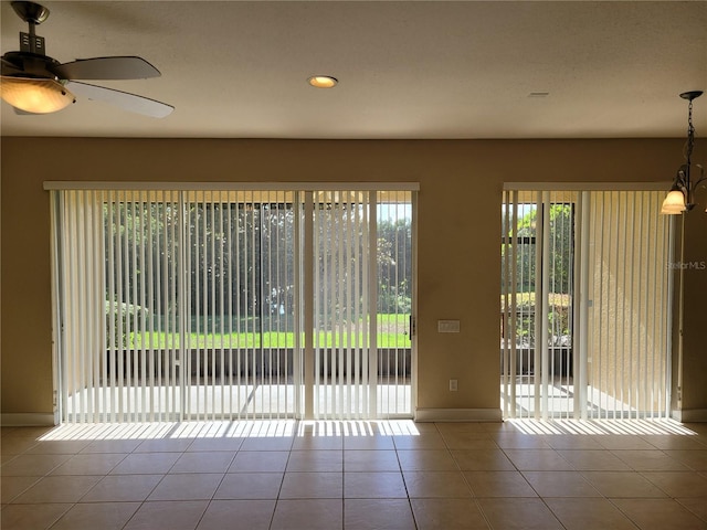 tiled empty room with baseboards, a ceiling fan, and recessed lighting