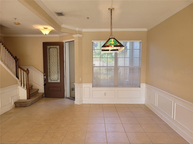 unfurnished dining area with a decorative wall, a wainscoted wall, stairs, ornamental molding, and light tile patterned floors