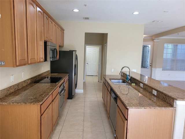 kitchen featuring a sink, stainless steel appliances, light tile patterned flooring, stone countertops, and recessed lighting