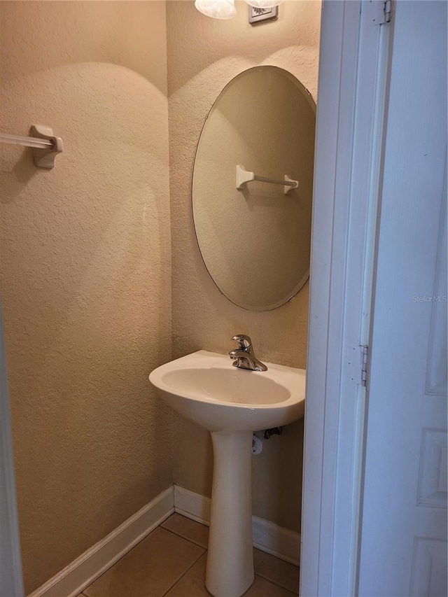 bathroom featuring tile patterned flooring and baseboards