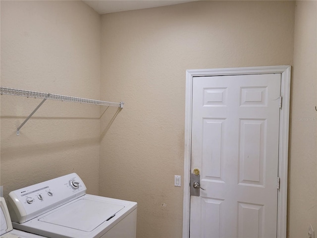 clothes washing area with washing machine and clothes dryer