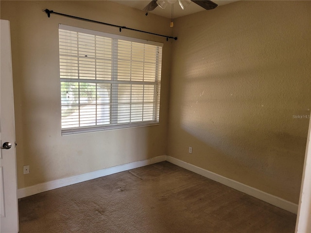 spare room featuring ceiling fan, baseboards, and carpet flooring