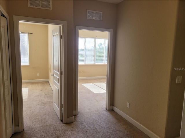 corridor featuring carpet and baseboards