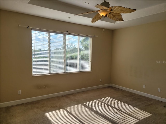 unfurnished room with a ceiling fan, carpet flooring, and baseboards