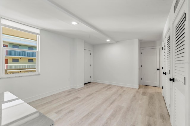 interior space with baseboards and light wood-style floors