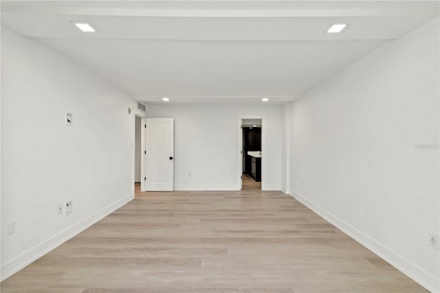 unfurnished room featuring baseboards, recessed lighting, and light wood-type flooring