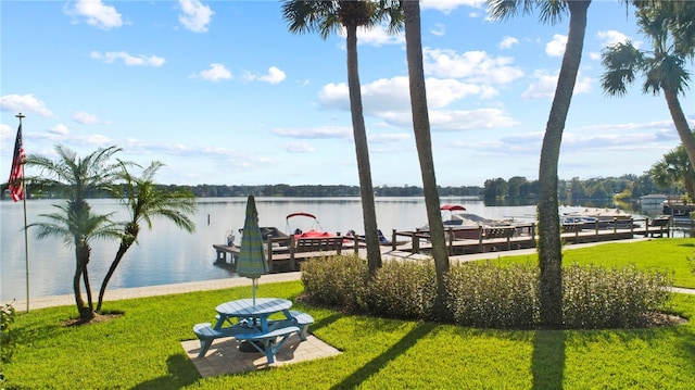 dock area with a water view and a yard