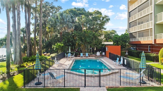 pool with fence and a patio area