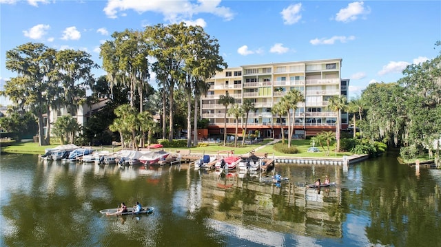 dock area featuring a water view and a lawn