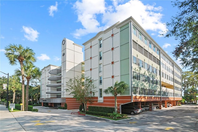 view of building exterior with covered parking
