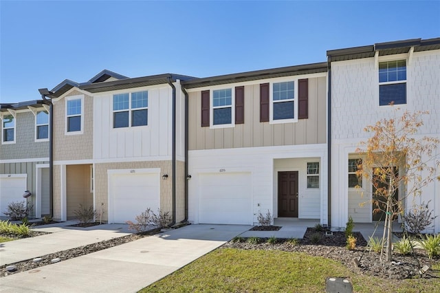 townhome / multi-family property with driveway and a garage