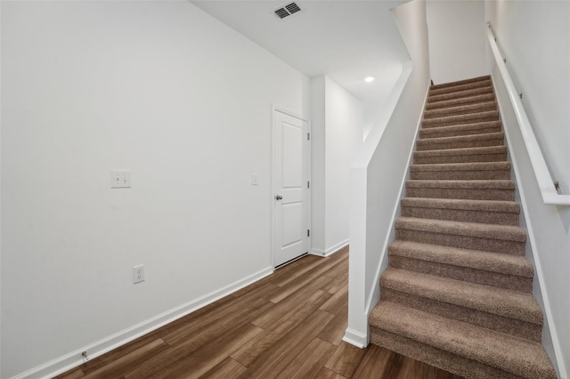 staircase with baseboards, visible vents, recessed lighting, and wood finished floors