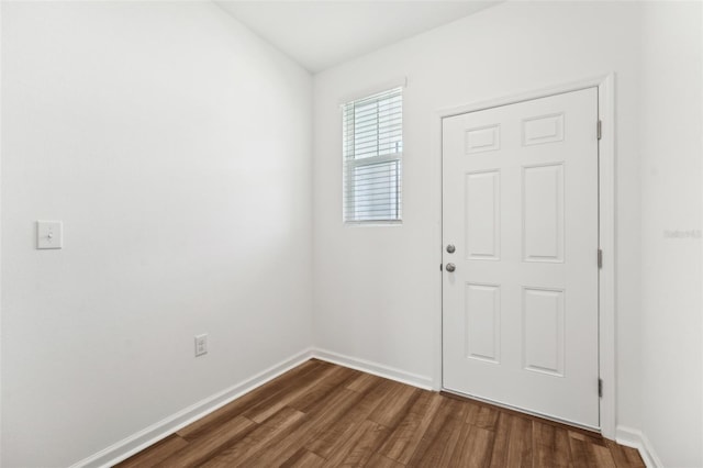 entryway with baseboards and dark wood-style flooring
